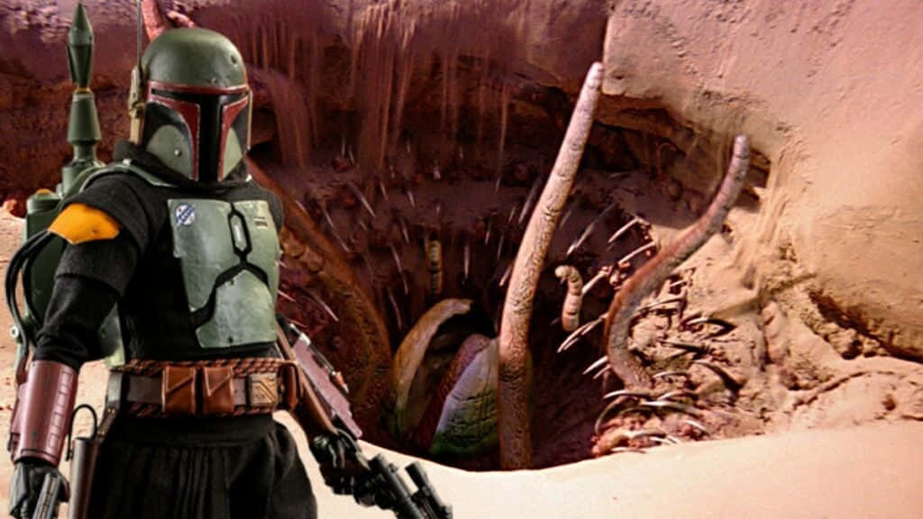 Sarlacc 桌布 壁紙 — 波巴·費特站在沙漠峽谷中，面對從洞中出現的巨大沙蟲。