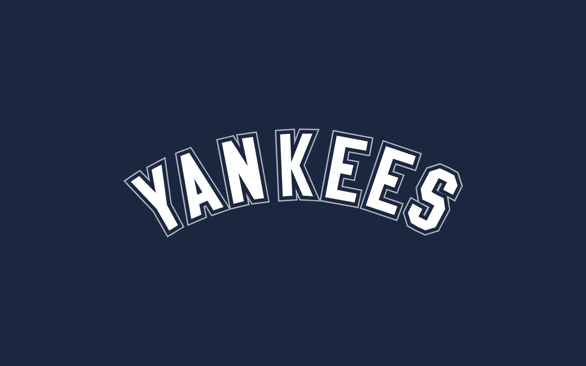 洋基隊棒球隊標誌 壁紙 — 粗體白色拱形 'YANKEES' 文字在純海軍藍色背景上突出顯示。