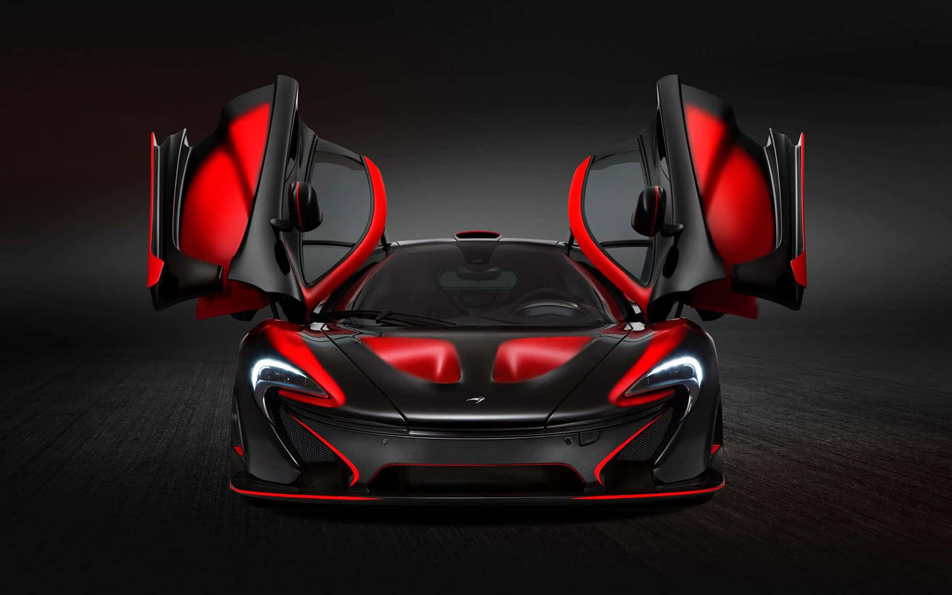 黑色和紅色McLaren超級跑車，在黑暗的工作室中打開鷗翼車門。