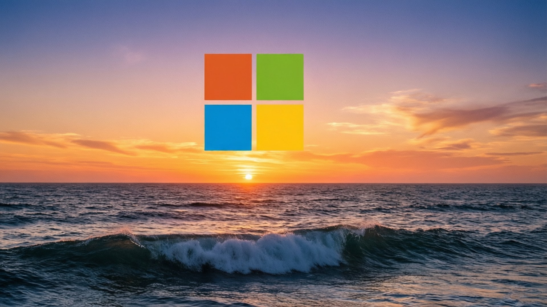 海洋日落 Microsoft 壁紙 — Microsoft 標誌漂浮在橙、粉紅和藍色天空的海浪上充滿活力的日落之上。