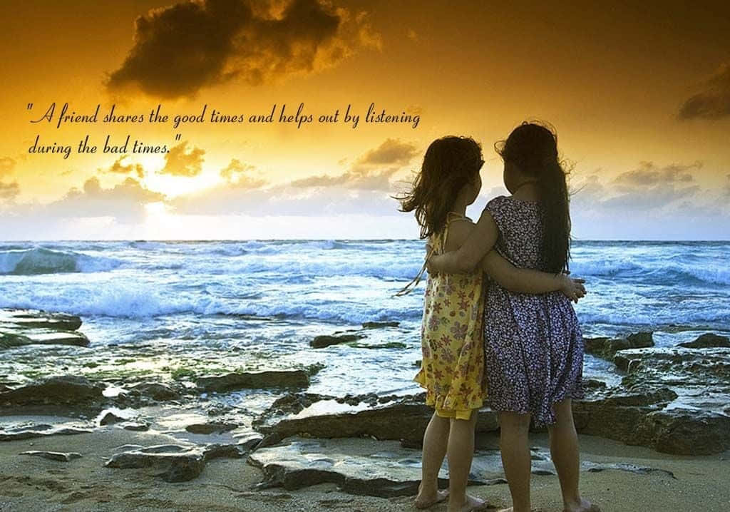兩個女孩在日落時分的海灘上擁抱，身後是海洋波浪。