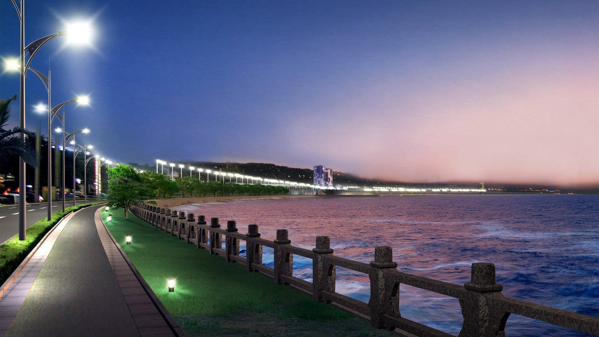 黃昏時分亮燈的海邊步道，遠方有海洋和城市燈光。