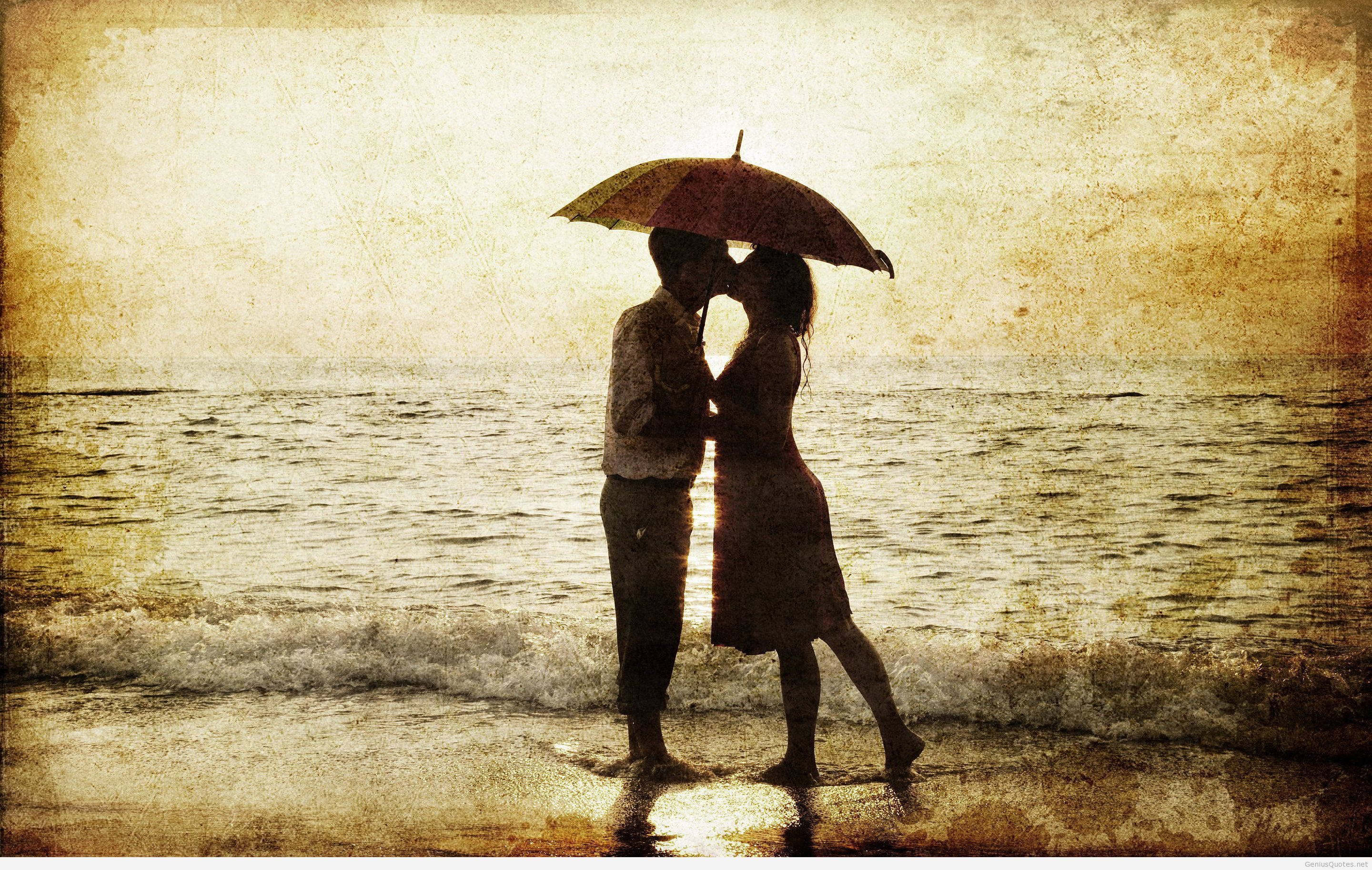 海邊的愛情故事 壁紙 — 一對剪影情侶在雨中沙灘上，於紅色雨傘下親吻，帶有紋理復古色調。