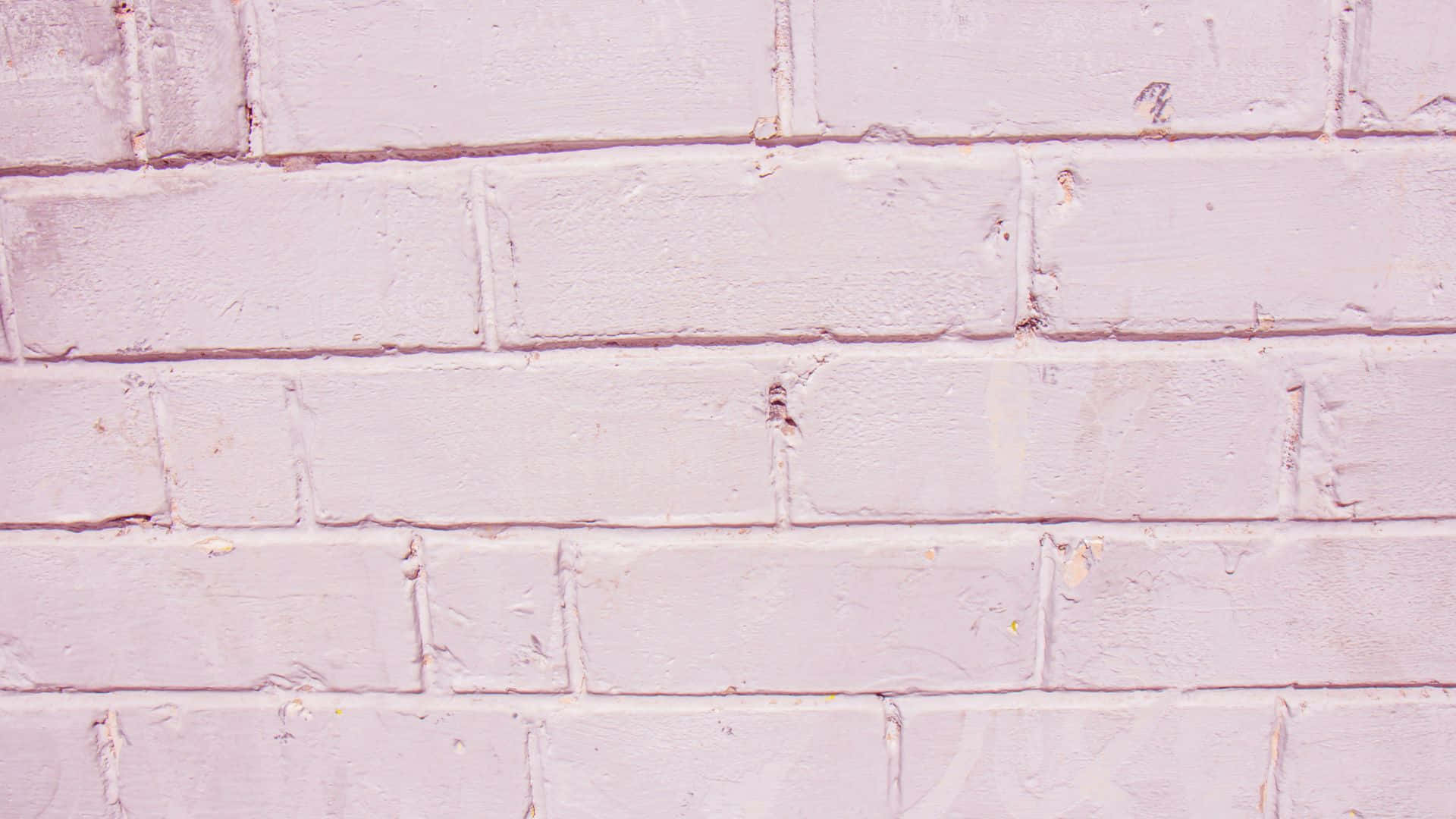 Pink Texture 桌布 壁紙 — 淡粉紅色油漆磚牆的特寫，顯示紋理和細微磨損。