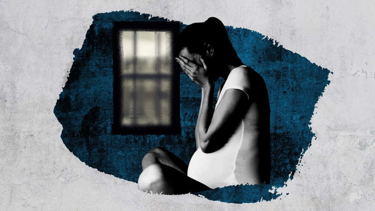 深思晚期墮胎的女性 壁紙 — 一名身穿白衣嘅女人喺一個有鐵窗嘅空房間裏面，彎腰坐低，用手掩面喊緊。