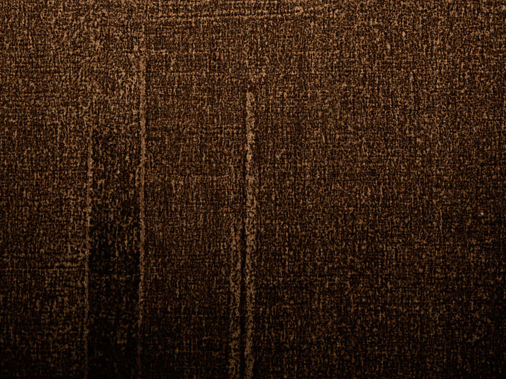Brown Texture 桌布 壁紙 — 深棕色紋理布料的特寫，帶有垂直縫線和微妙的色調變化。