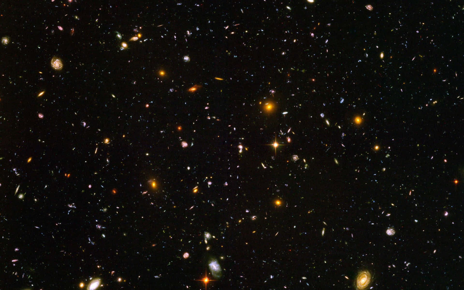 廣闊的宇宙場景，充滿了遙遠的星系和明亮的恆星，背景是黑色的虛空。