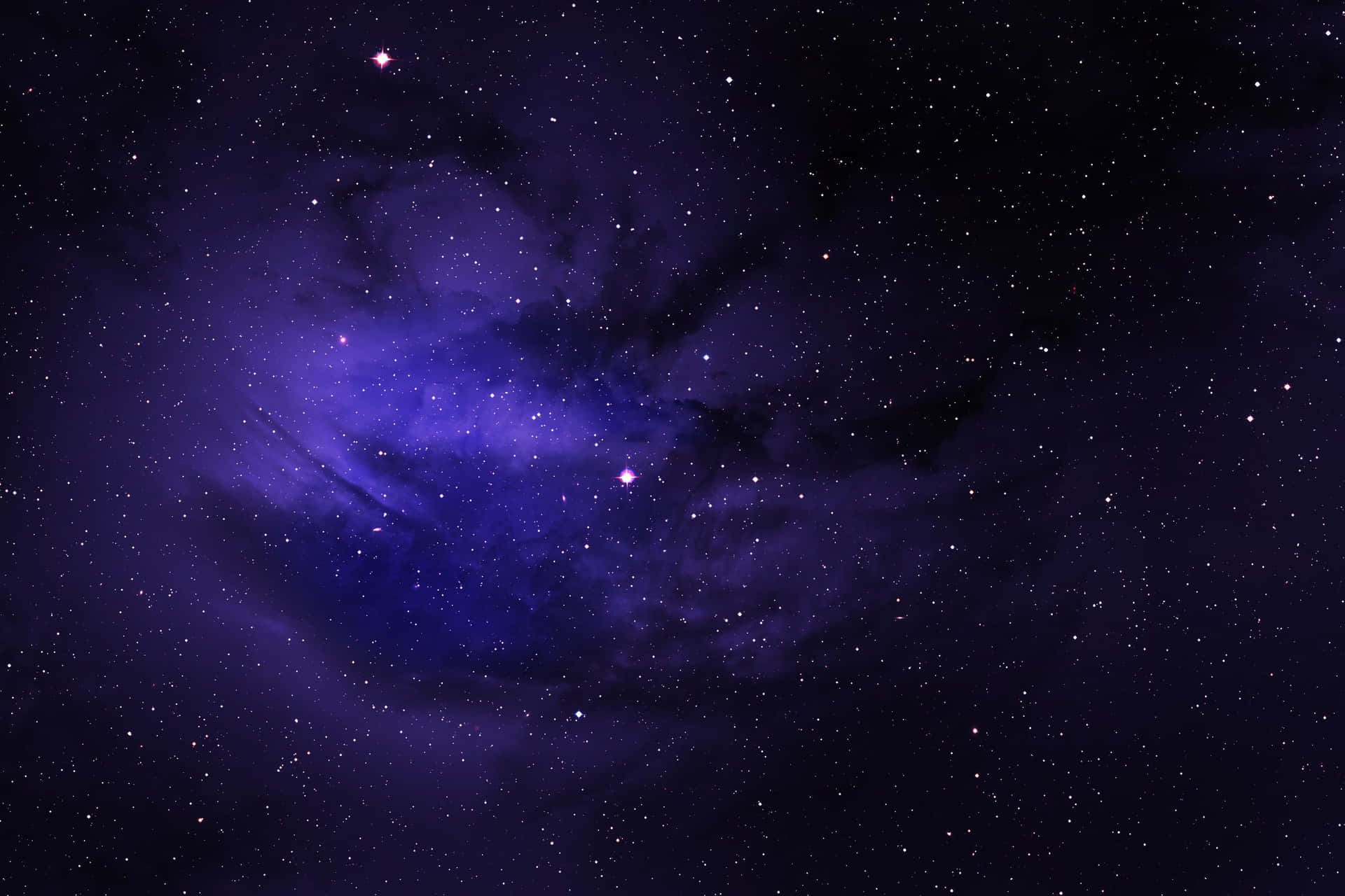 夜空中星辰閃耀的廣闊紫色星雲。