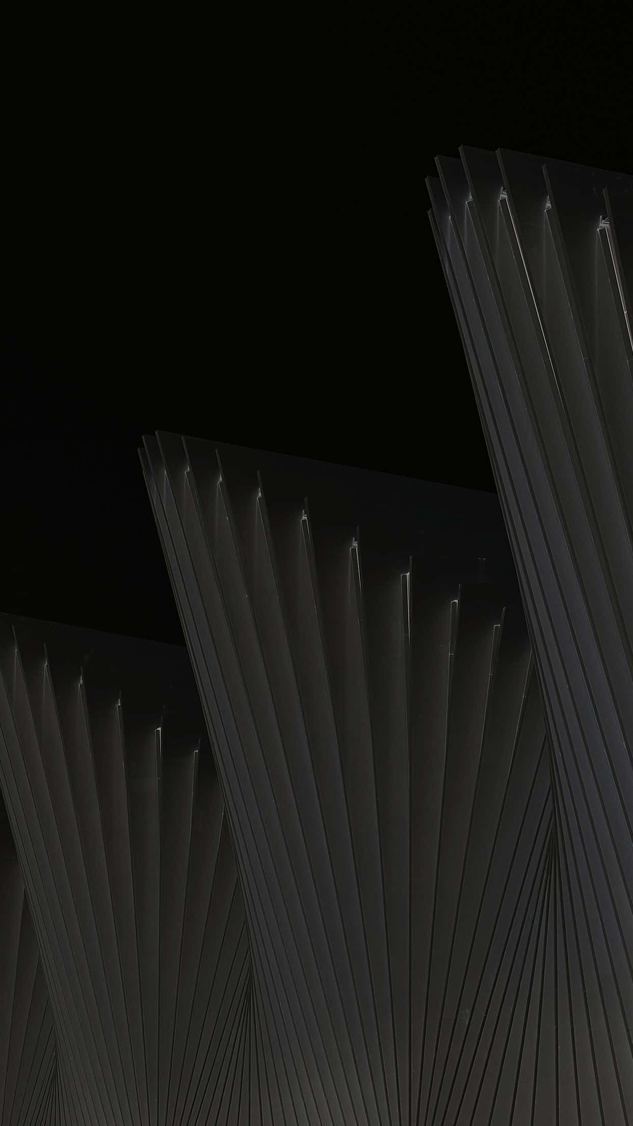 Black And White Architecture 桌布 壁紙 — 深色幾何建築鰭片在黑色夜空下散發柔和光芒。