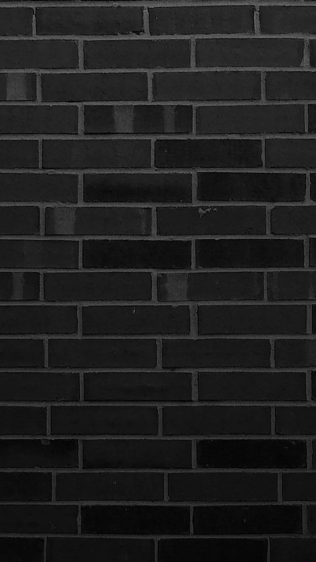 bricks 桌布 壁紙 — 深色磨砂黑磚牆的特寫，帶有細微紋理和淺灰色砂漿線。