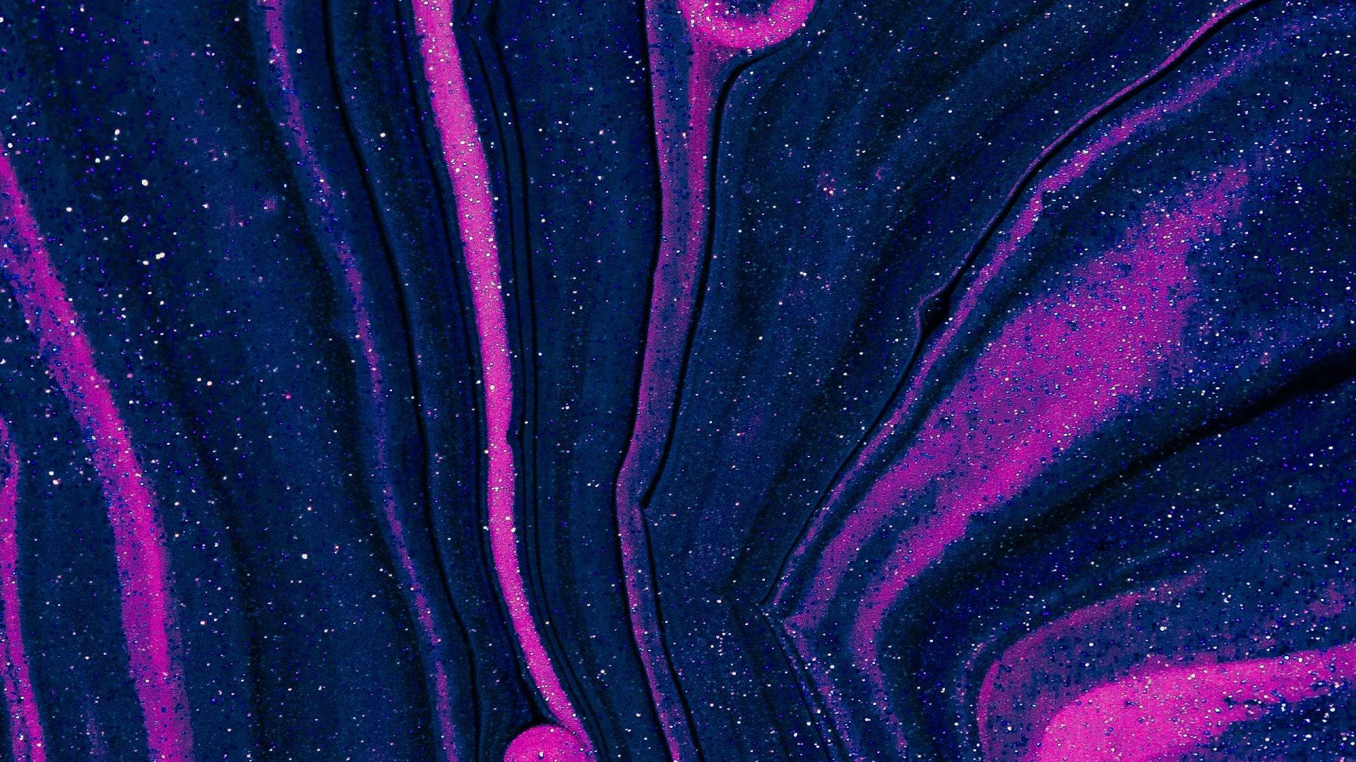宇宙抽象藝術，帶有洋紅色和藍色流體漩渦及閃爍斑點。
