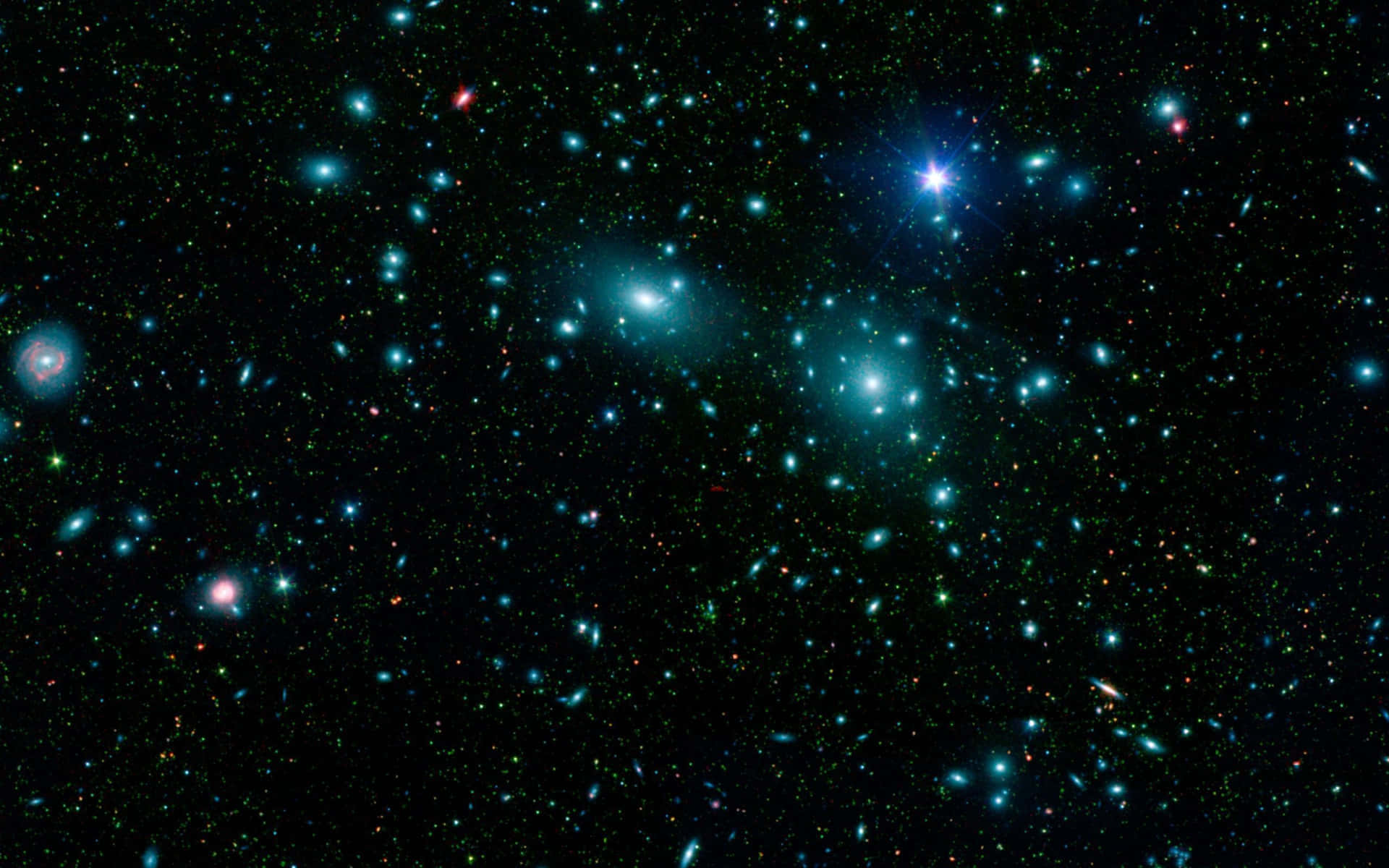 一個星場，在深空中充滿了發光的藍色和藍綠色星星以及遙遠的星系。