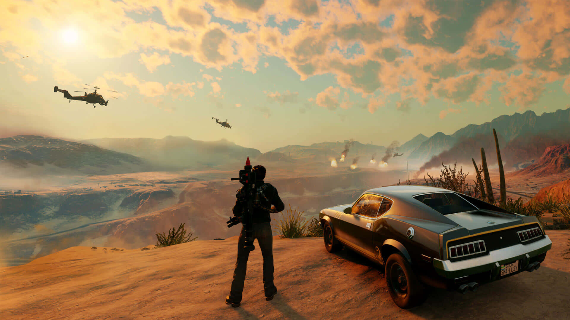 混亂釋放：1920x1080 解析度的 Just Cause 4 精彩背景 壁紙 — 一個孤獨的武裝人物站在沙漠山脊上，旁邊是一輛經典肌肉車，直升機在金色夕陽天空下飛過。