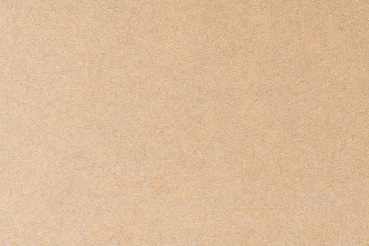 Brown Texture 桌布 壁紙 — 淺啡色光滑紙張表面的特寫，帶有細微纖維紋理和均勻光線。