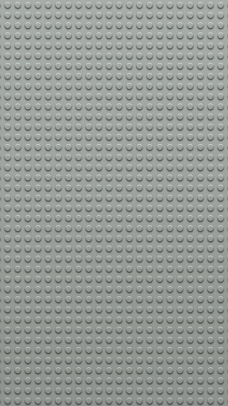 灰色LEGO底板，帶有重複的圓形凸點用於搭建。