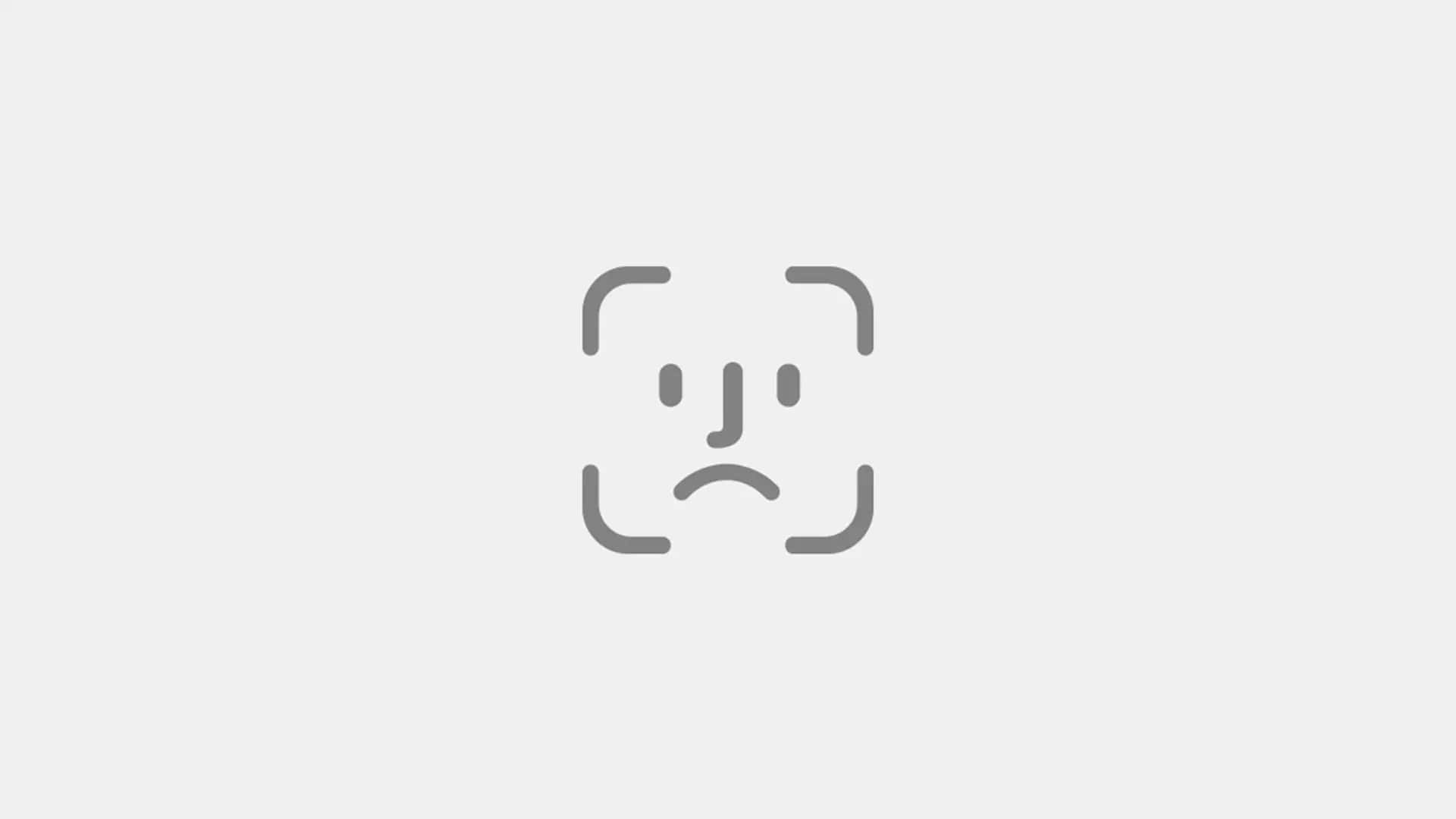 Face Id 桌布 壁紙 — 淺灰色背景上相機框內悲傷臉孔的極簡灰色線條圖示。