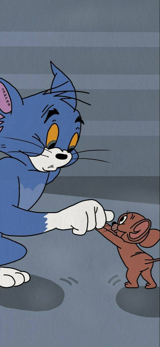藍色卡通貓 Tom 在追逐場景中指向小棕色老鼠 Jerry。