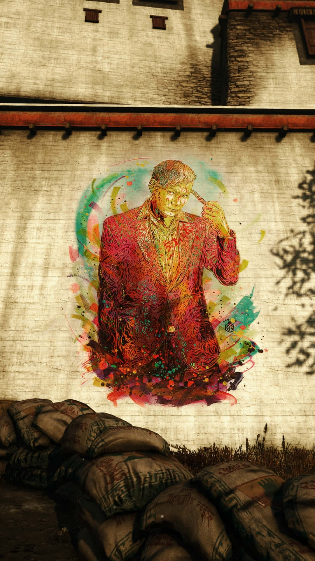 準備在手機上體驗革命性的《孤島驚魂4》 壁紙 — 一幅充滿活力的塗鴉壁畫，描繪一個穿紅色西裝的男人拿著香煙，畫在一個風化的牆上，旁邊有沙包。