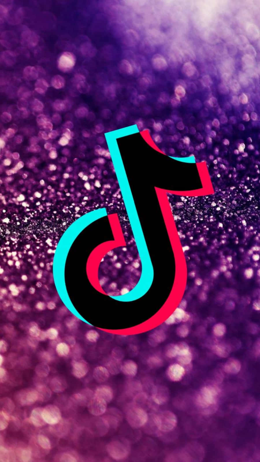 準備好在TikTok上分享獨特影片吧！ 壁紙 — TikTok 標誌居中於閃爍的紫色閃粉背景上，帶有散景燈光效果。