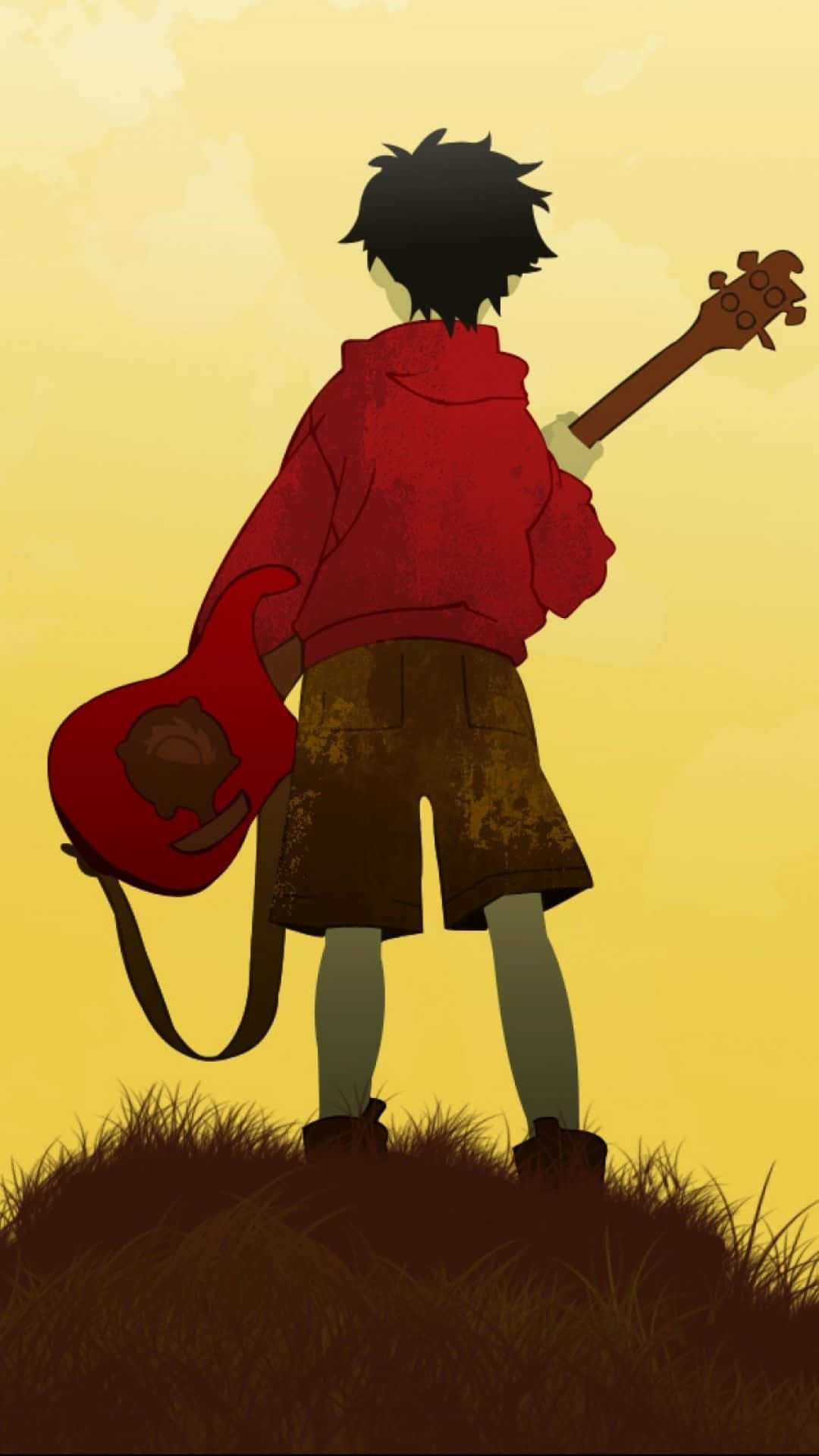 年輕動漫音樂家手持紅色結他，站在夕陽下的草丘上。