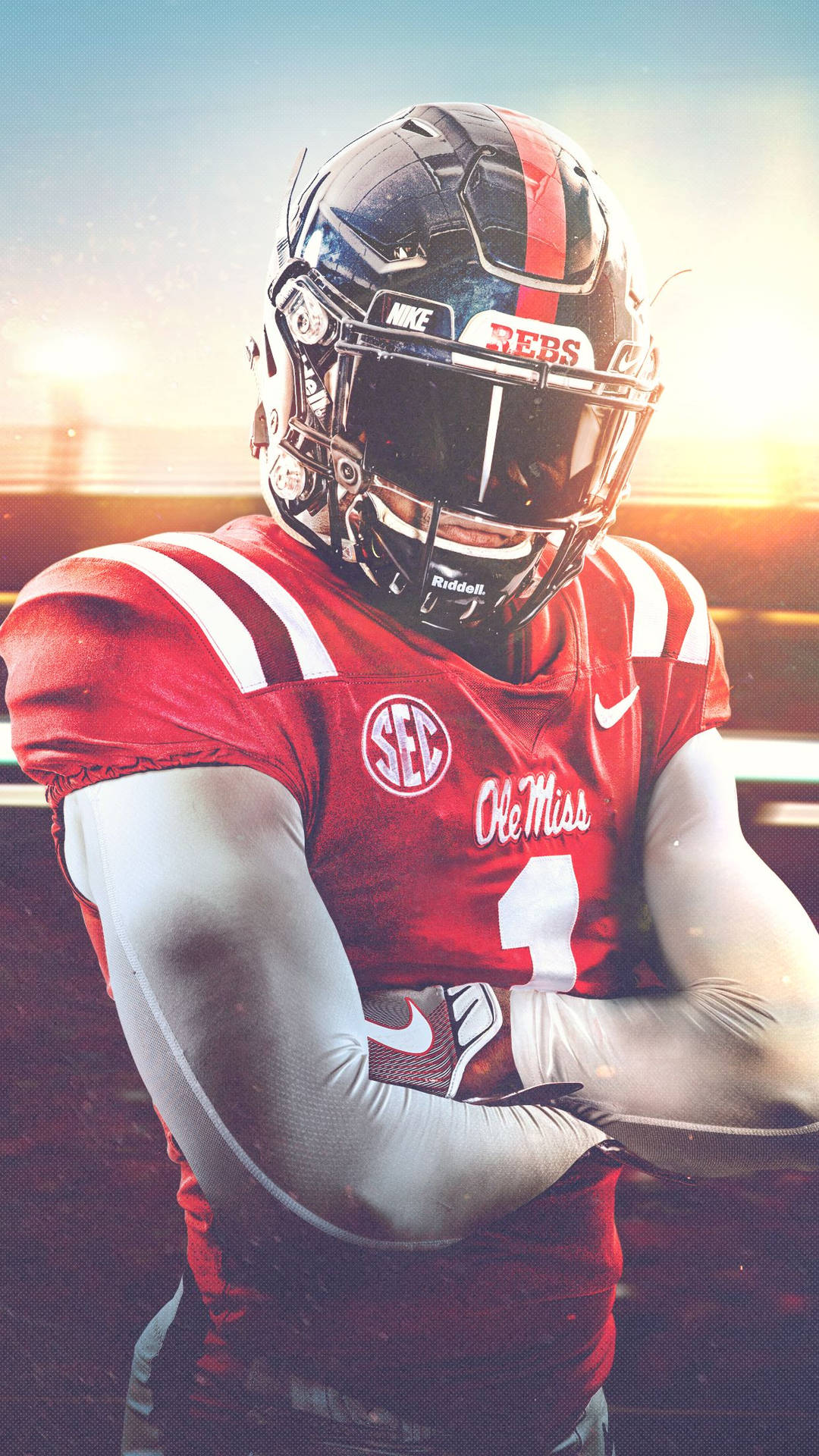 Ole Miss 足球員身穿紅色制服，在夕陽下交叉雙臂。