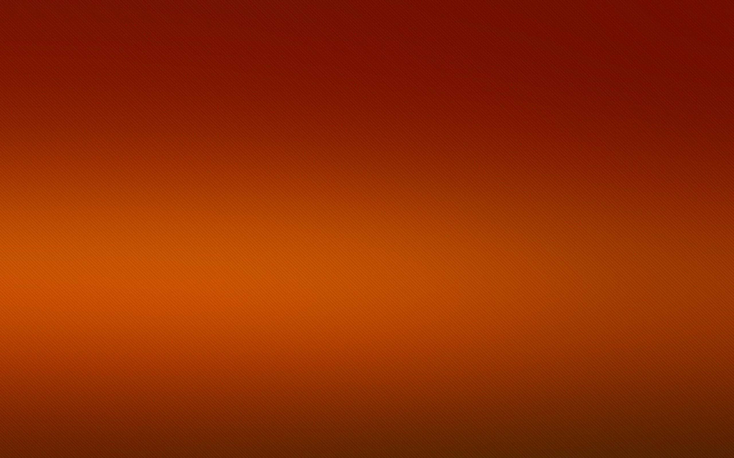 溫暖的深橙色光球 壁紙 — 從深紅色到暖橙色的平滑漸變，整個畫面帶有微妙的紋理圖案。