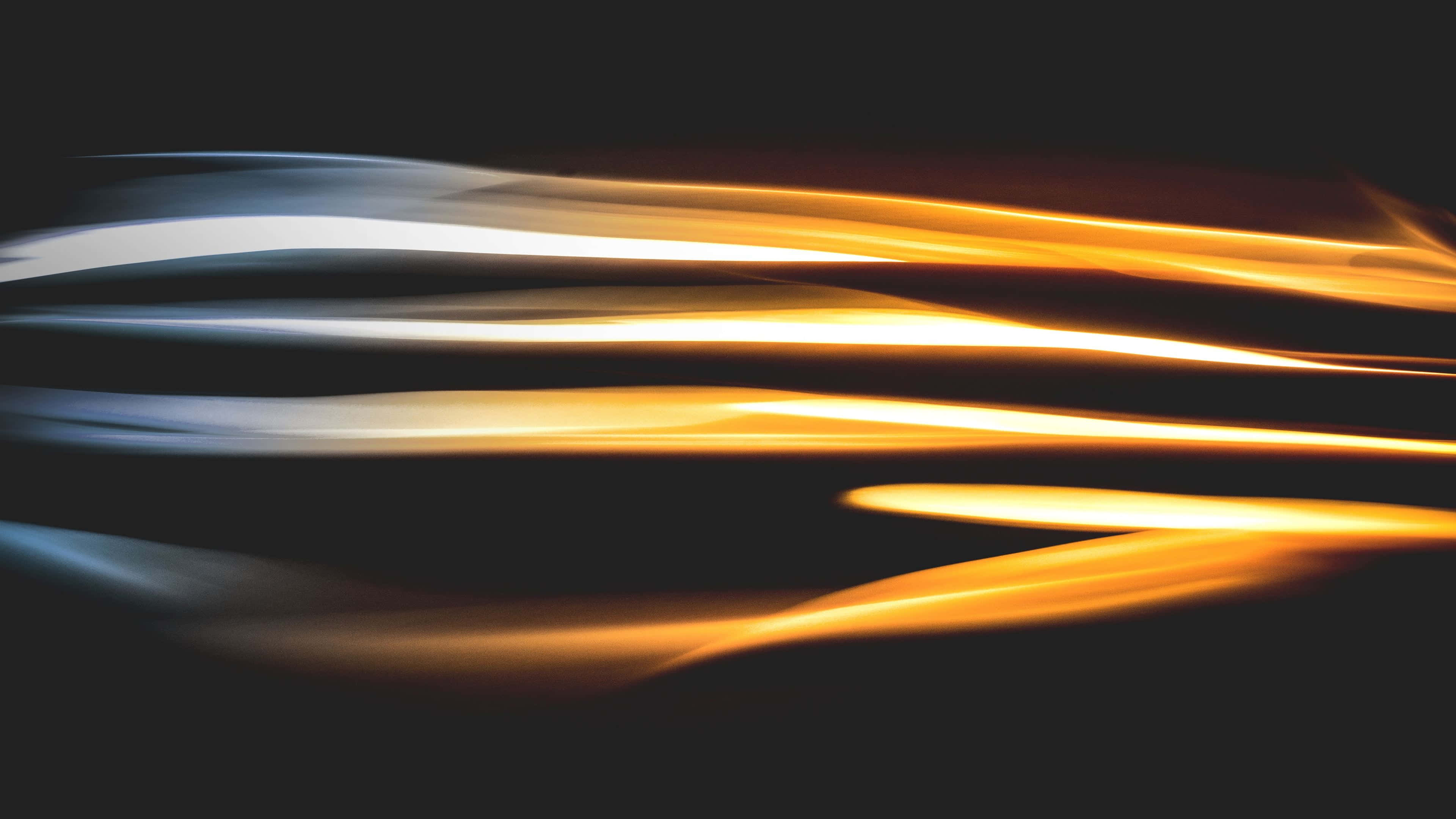Motion Blur 桌布 壁紙 — 溫暖金色與冷藍色光的動態條紋在深黑色背景上模糊，營造出高速運動的感覺。