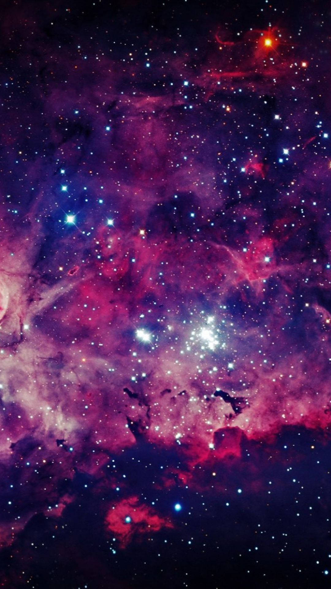 滿天繁星的可愛星系 壁紙 — 充滿活力的宇宙星雲以洋紅色和靛藍色旋轉，閃爍的星星散落在深邃的太空之中。