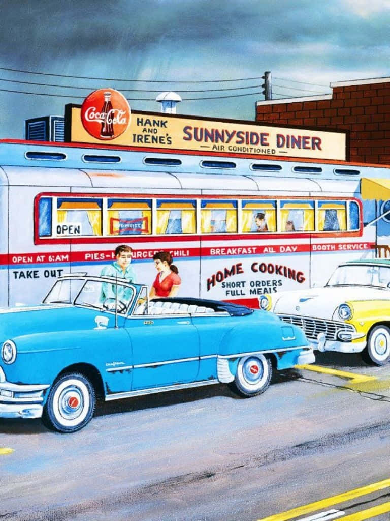 一輛藍色1950年代敞篷車停在一間帶有可口可樂標誌的復古餐廳外。