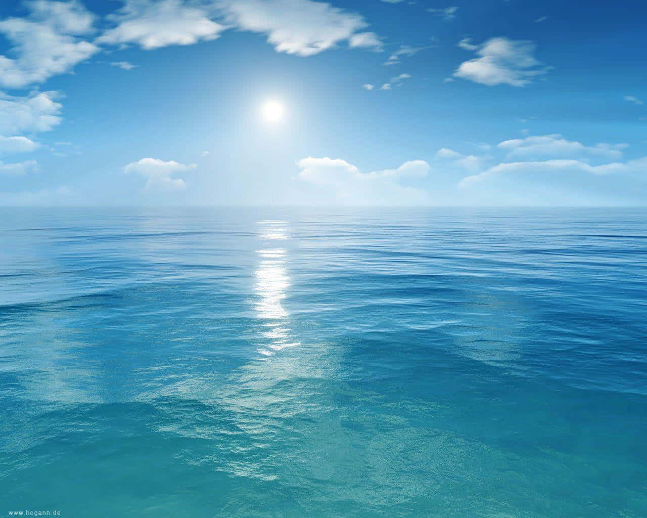 陽光在藍天白雲下平靜的海面上反射。
