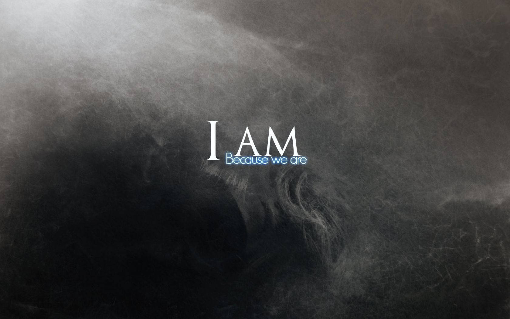 文字 I AM Because we are 在黑暗旋轉的煙霧中發光。