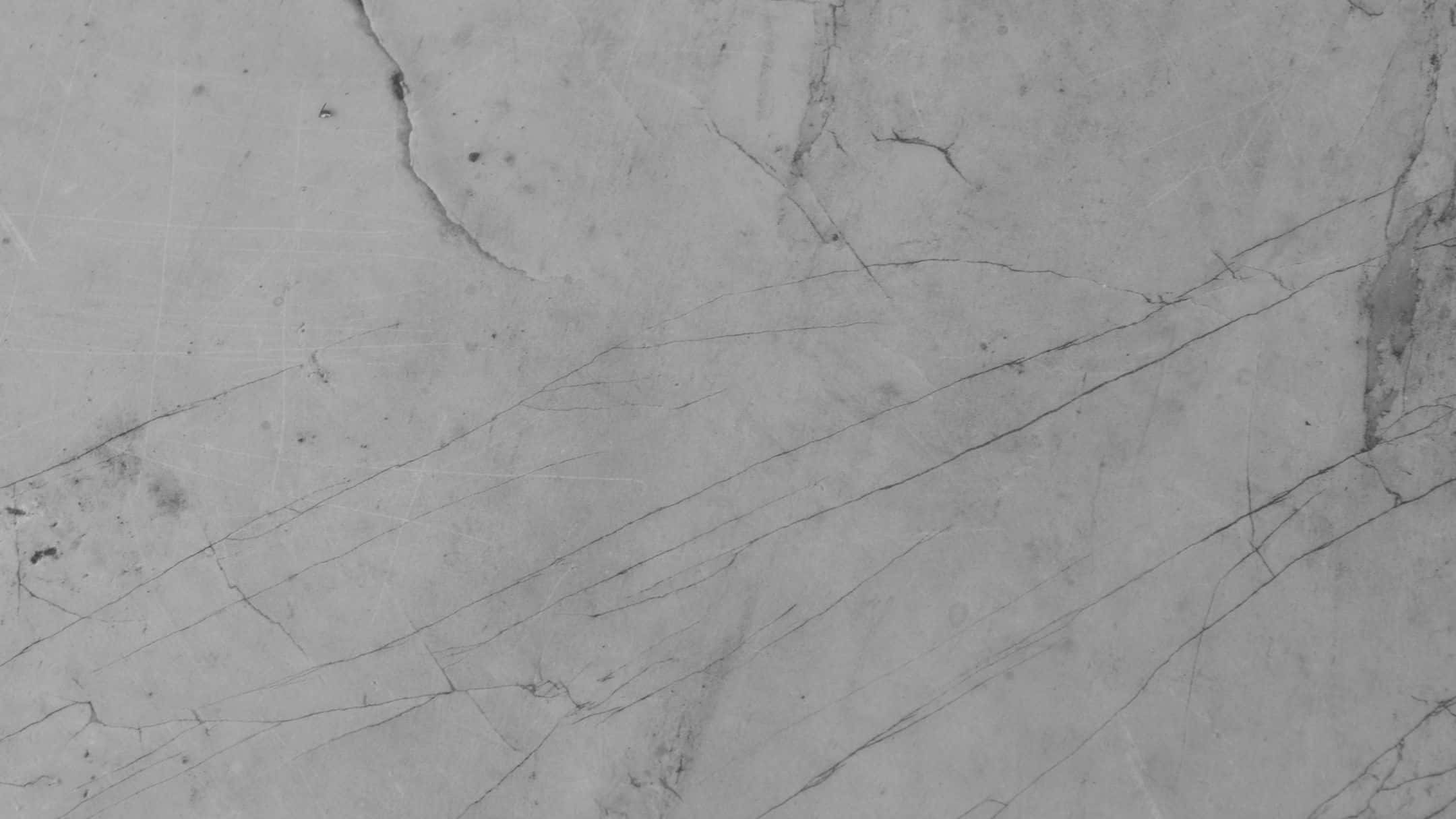 Grey Marble 桌布 壁紙 — 灰色大理石表面的特寫，帶有複雜的深色紋理和細微質感。
