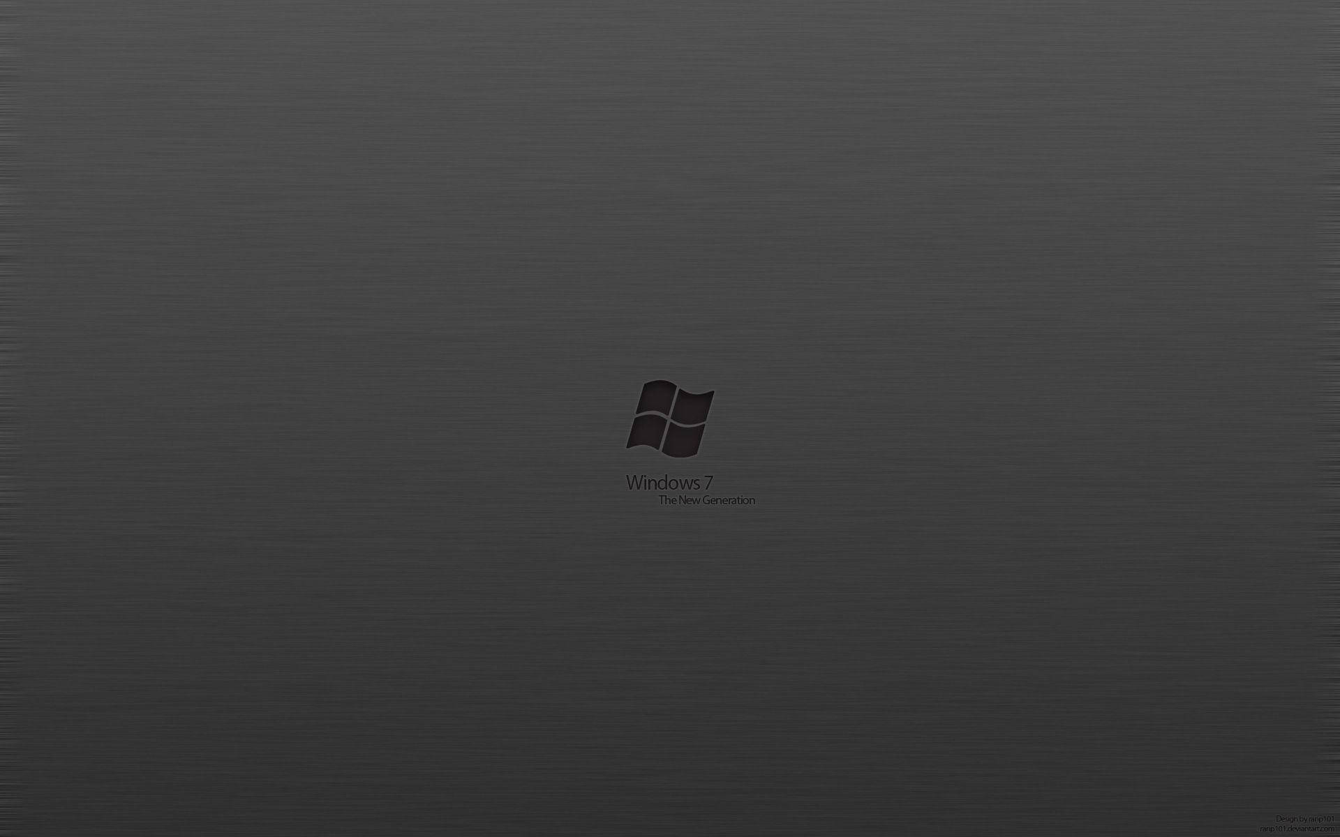 灰調極簡暗色 Windows 7 壁紙 — Windows 7 標誌居中顯示在帶有細微紋理的深灰色拉絲金屬背景上。
