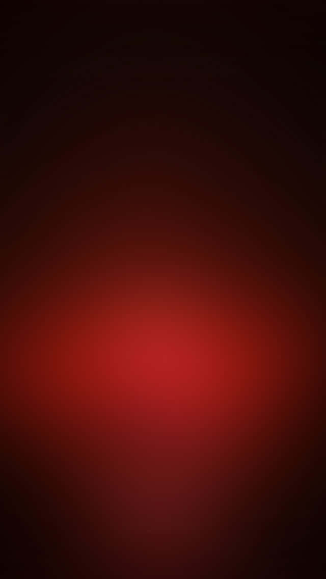 為你的 iPhone 添上一抹亮色，獨特黑紅設計盡顯時尚 壁紙 — 深紅色漸變從明亮的中心向黑暗背景輻射。