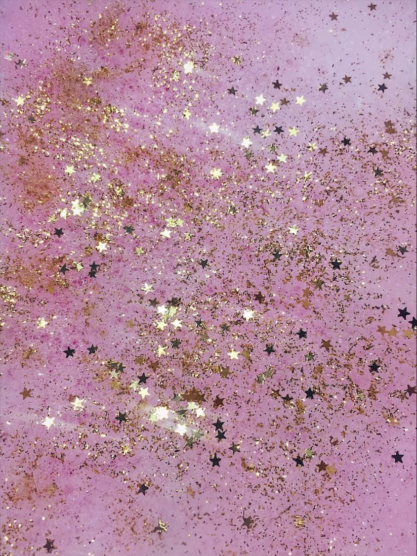 粉紅色表面覆蓋金色和黑色星星閃粉，營造出神奇的閃爍效果。