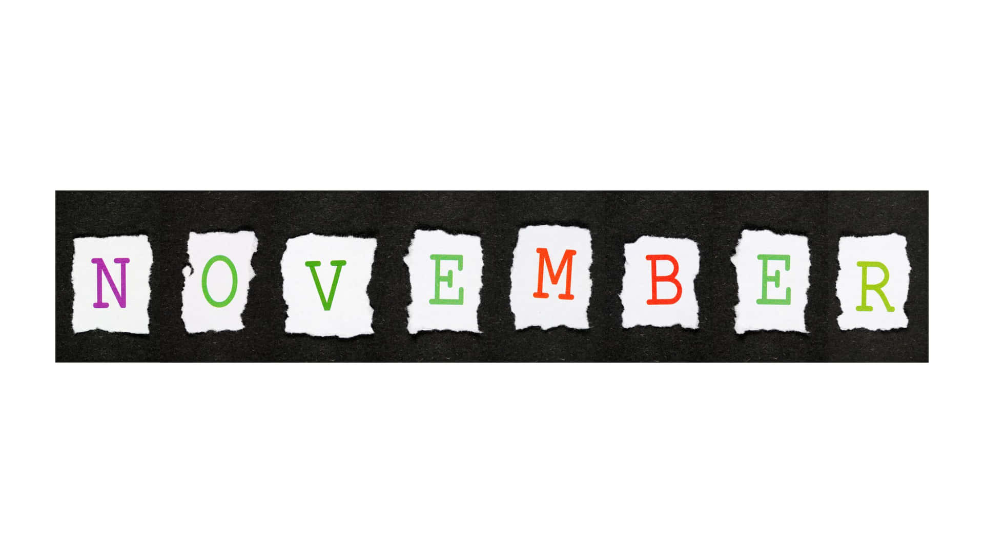 撕紙字母在黑色背景上拼出 november，顏色為紫色、綠色和橙色