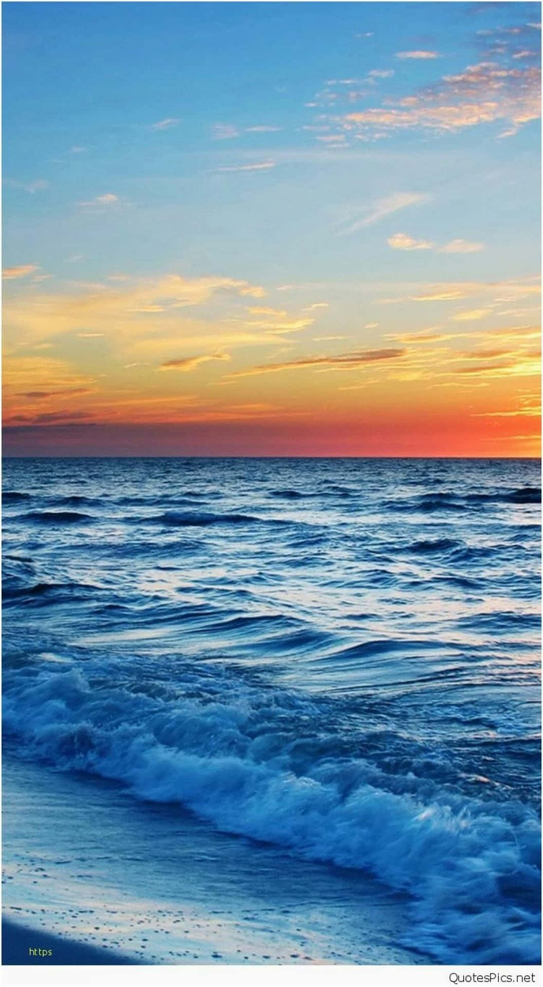 在充滿活力的夕陽天空下，海浪拍打著海岸。
