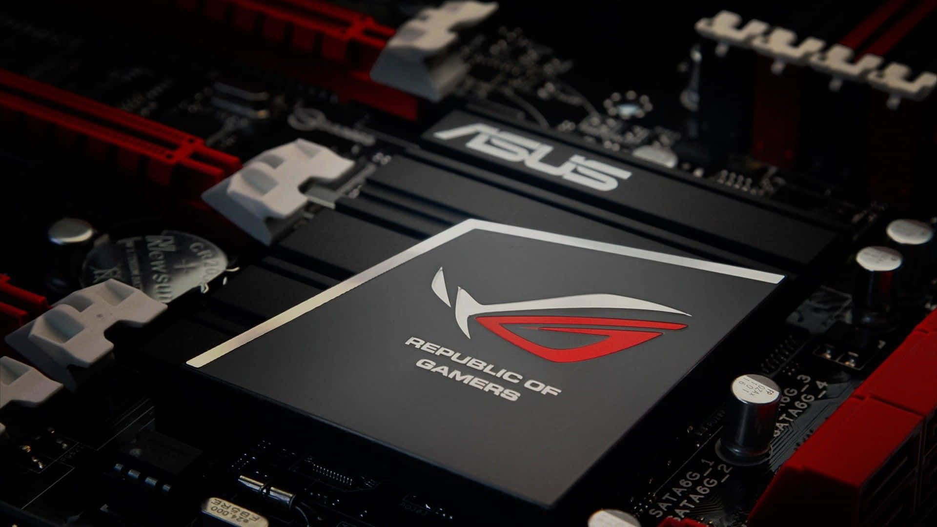無與倫比的遊戲體驗，來自 ASUS ROG 壁紙 — ASUS ROG 主機板特寫，紅色和黑色組件在戲劇性燈光下。