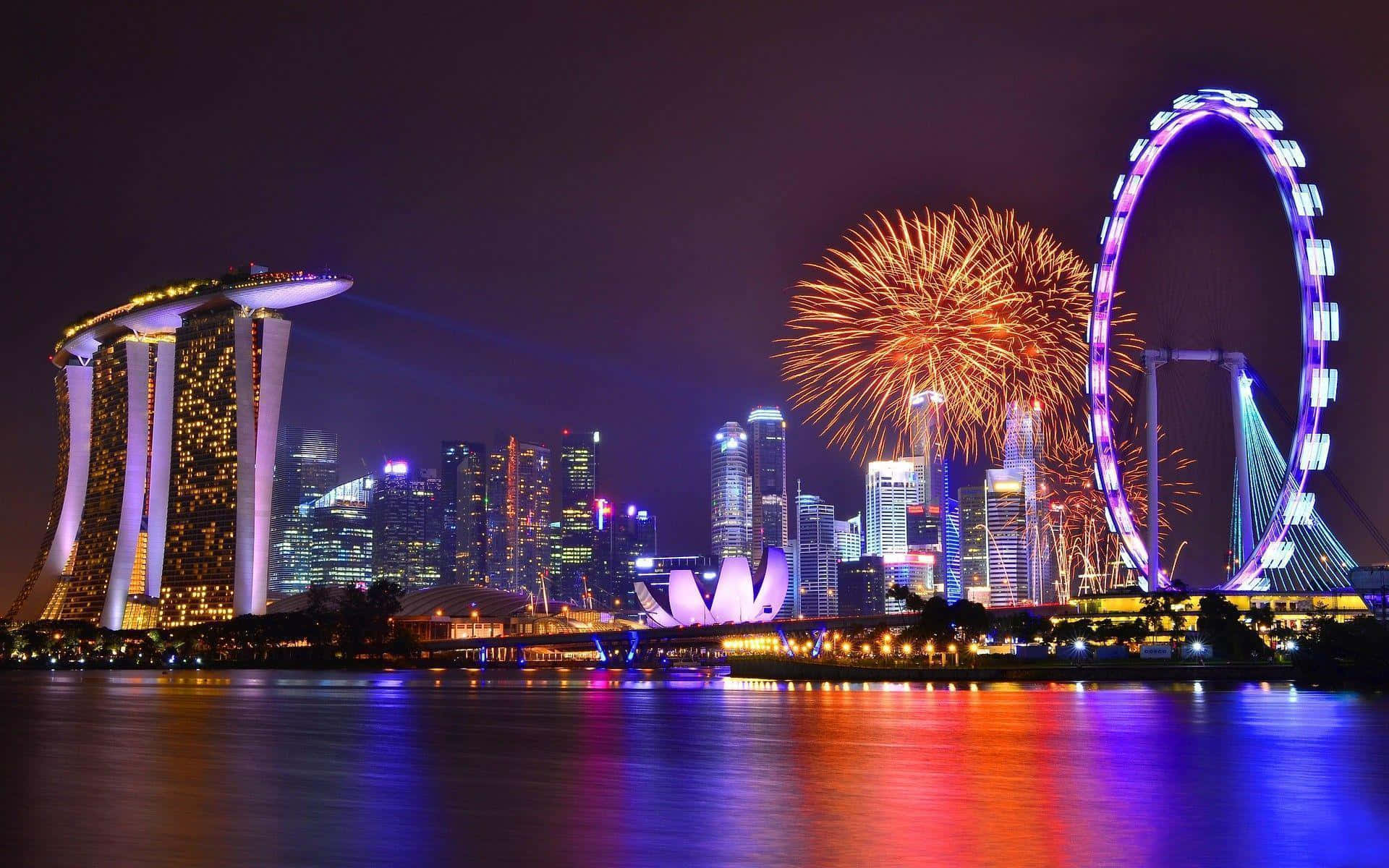 Singapore 桌布 壁紙 — 煙花在新加坡閃爍的天際線上綻放，濱海灣金沙和新加坡摩天輪在夜晚被照亮。