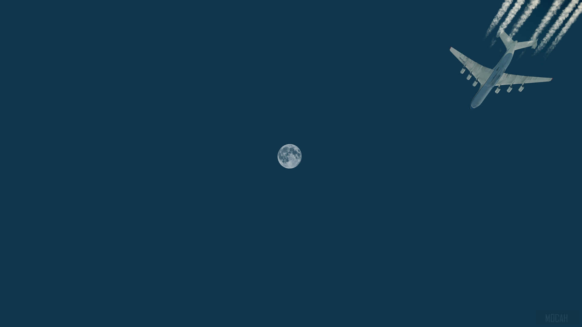 一架飛機在夜間飛行，背景是滿月。