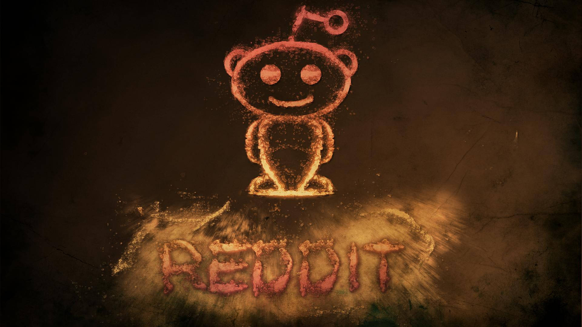 發光的 Reddit 外星人標誌由灰塵製成，下方有「REDDIT」文字，深色背景。