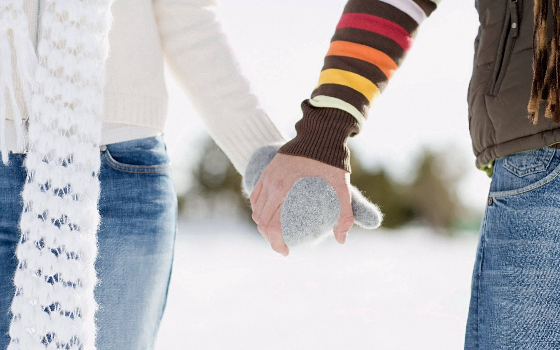 牽手的友誼 壁紙 — 兩人在雪地冬日天氣中手牽手，穿著舒適的冬裝和連指手套。