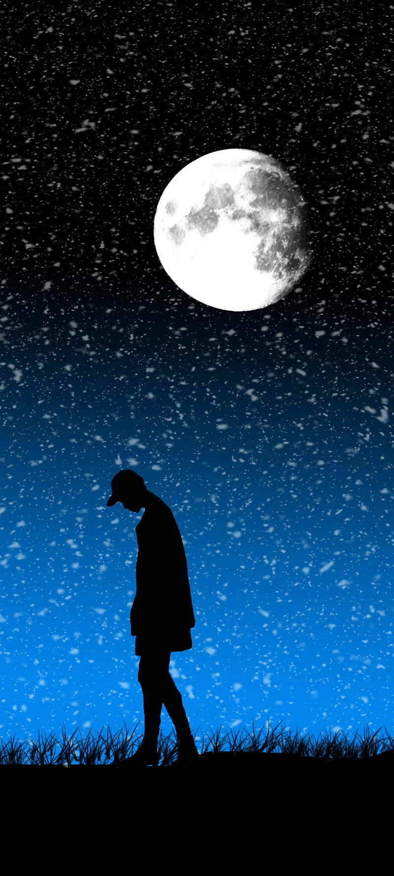 一個人在夜晚的滿月下雪中行走的剪影。