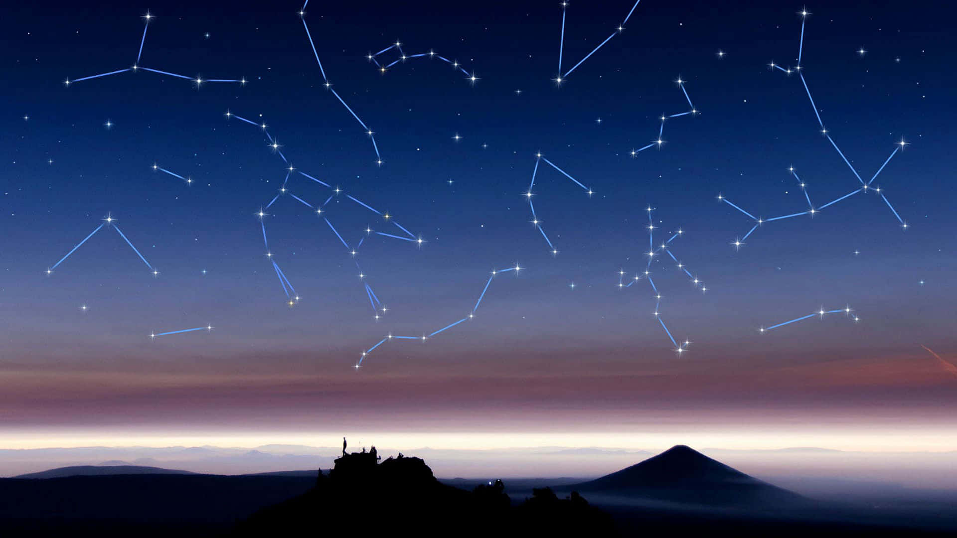 人們在山頂觀看暮色天空中的星座。