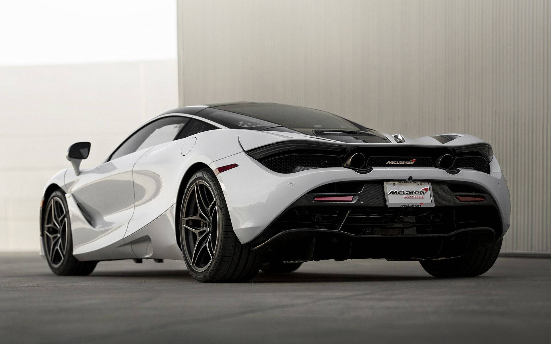 珍珠白麥拉倫720S Spider 壁紙 — 一架時尚的白色McLaren跑車帶黑色點綴，停放在室內，背景是簡約的混凝土牆。