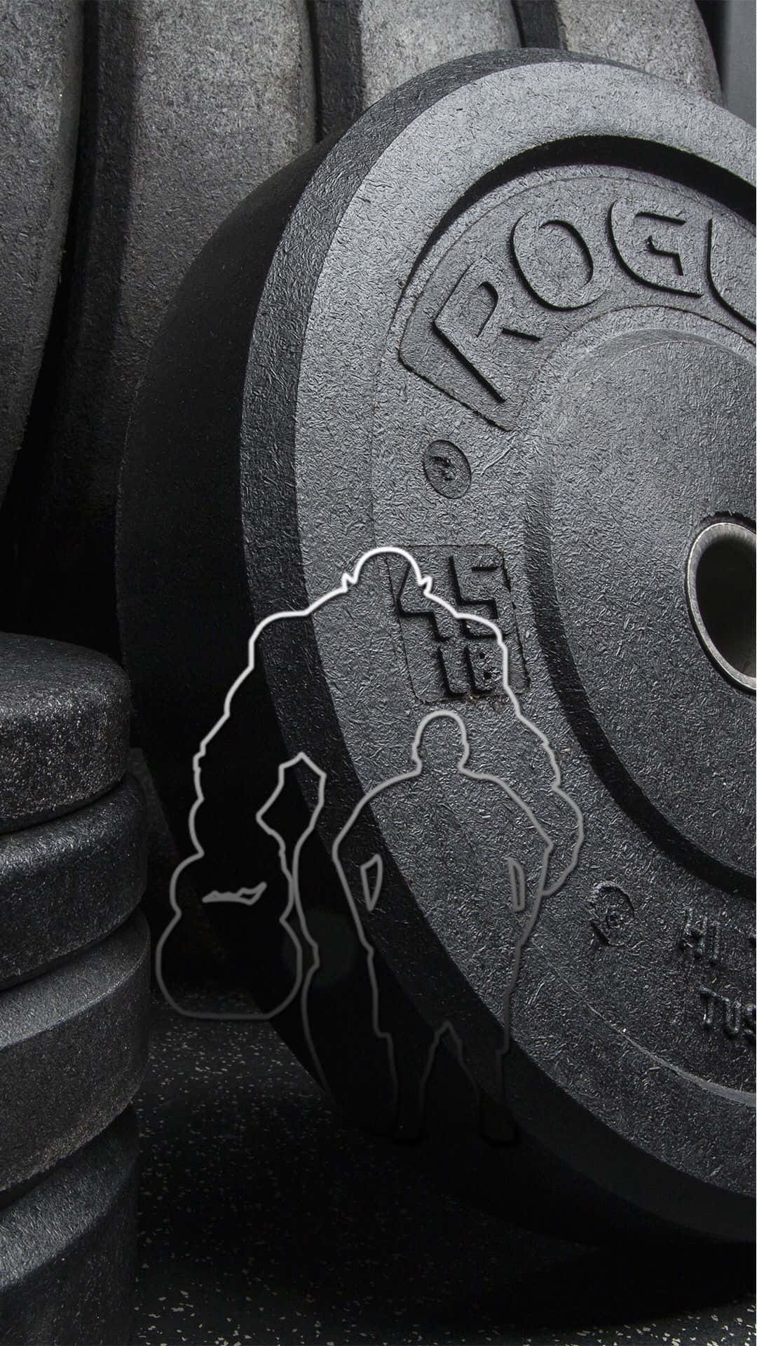 帶有舉重運動員剪影的槓鈴片，健身室地板