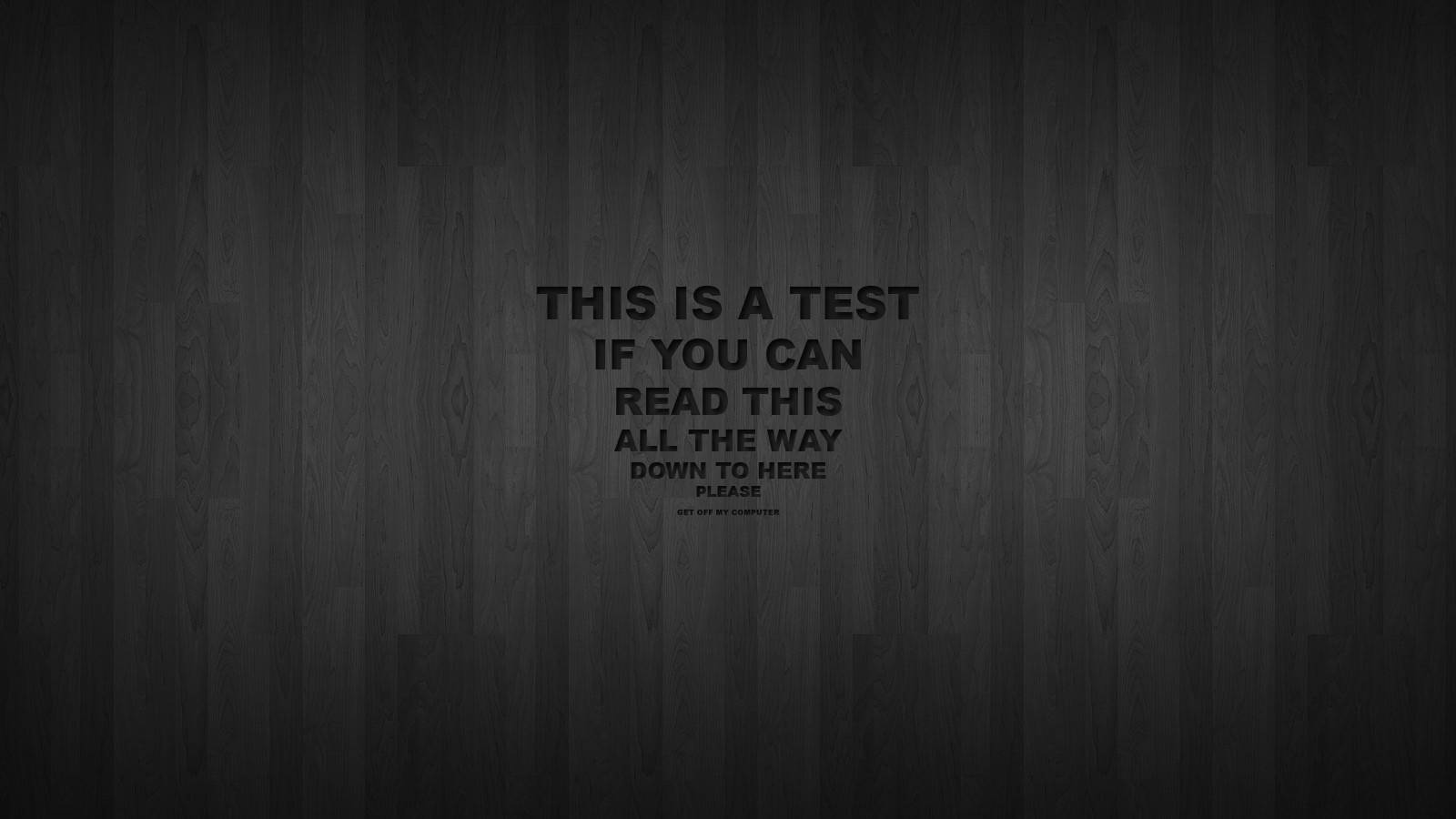 深色木紋背景，中央粗體文字顯示「THIS IS A TEST IF YOU CAN READ THIS ALL THE WAY DOWN TO HERE PLEASE」