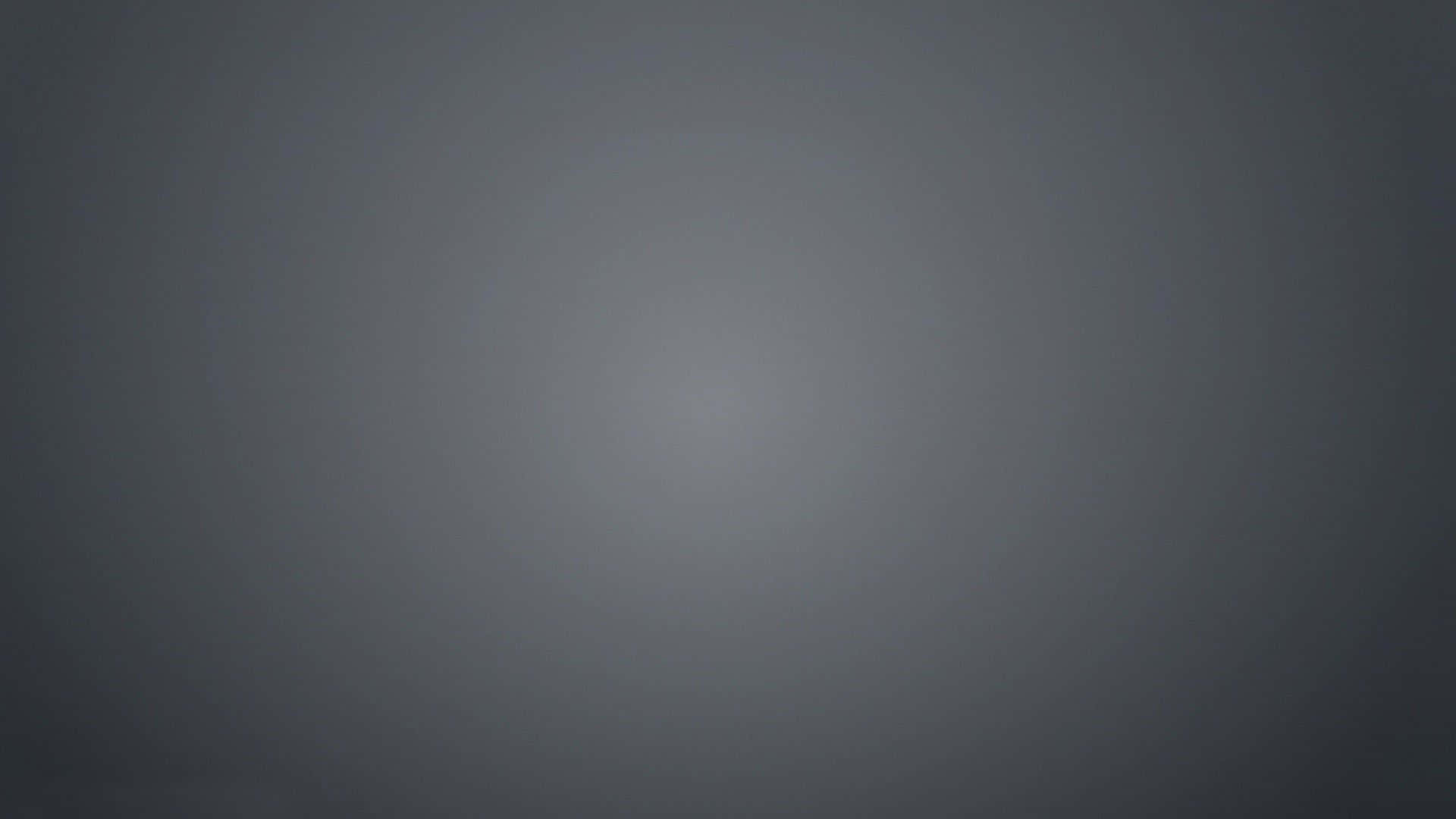 現代灰階抽象漸層背景 壁紙 — 一個極簡漸變背景，從深灰色過渡到淺灰色，帶有柔和放射狀照明。