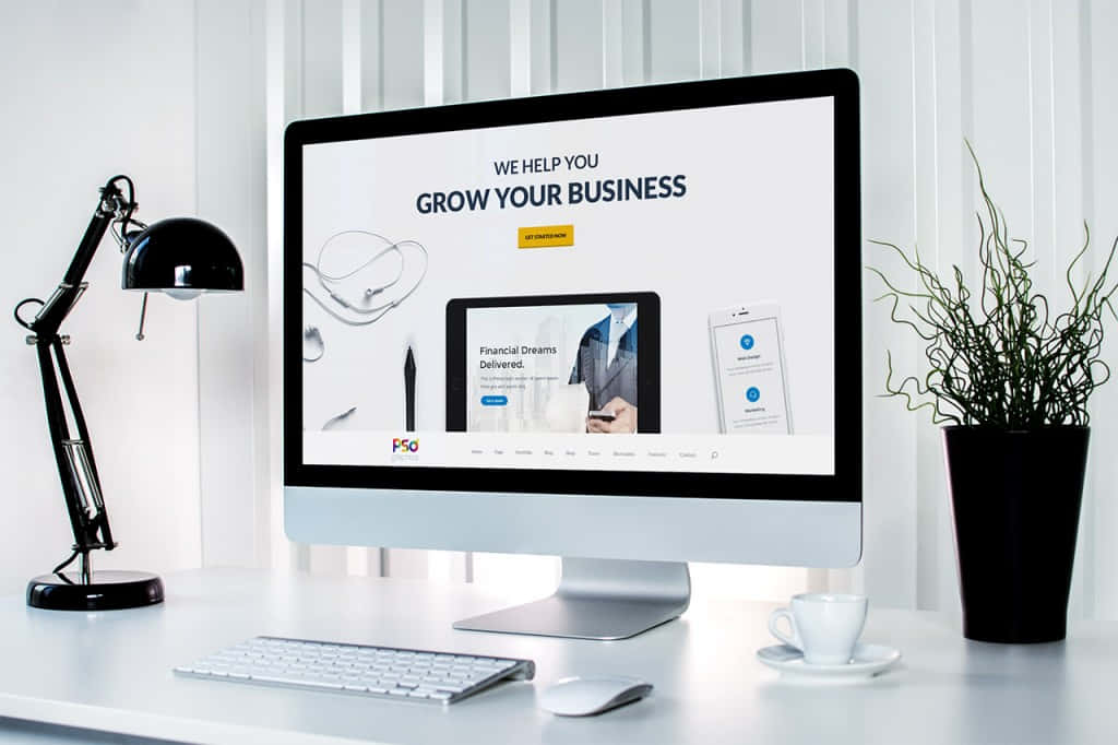 Website 桌布 壁紙 — 現代簡約辦公桌設置，配備時尚 iMac 顯示商業增長網站，旁邊有黑色檯燈和盆栽植物。