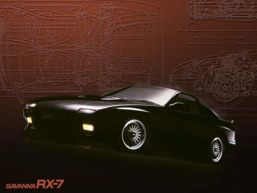 黑色萬事得Savanna RX-7跑車在橙色技術圖紙背景下閃耀著發光的車頭燈。
